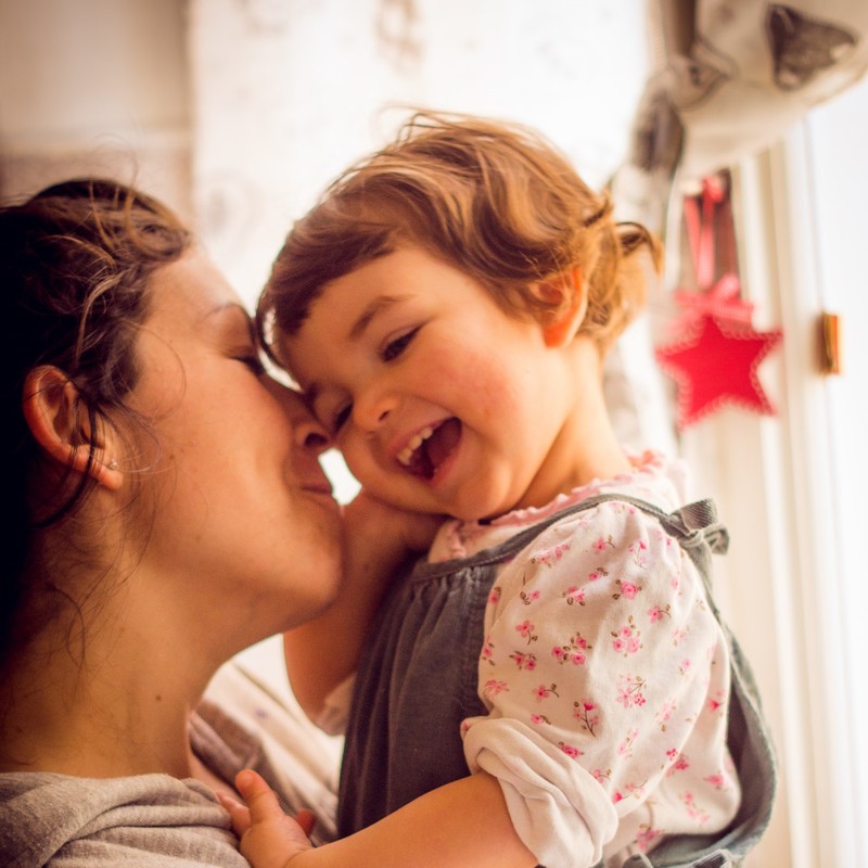 A mother cuddles with her daughter. A mother cuddles with her daughter.