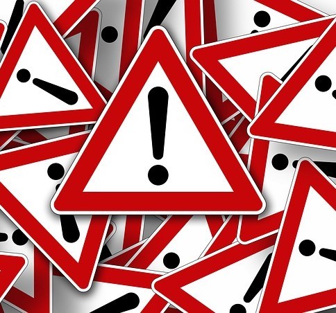 Road side traffic sign displaying the symbol for caution, an exclamation point. Road side traffic sign displaying the symbol for caution, an exclamation point.