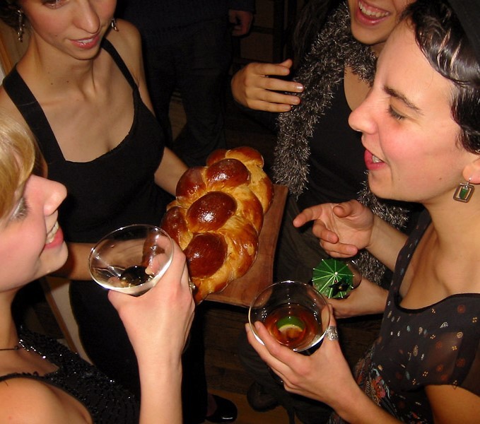 Guests at a cocktail party stand close together during a conversation. Guests at a cocktail party stand close together during a conversation.