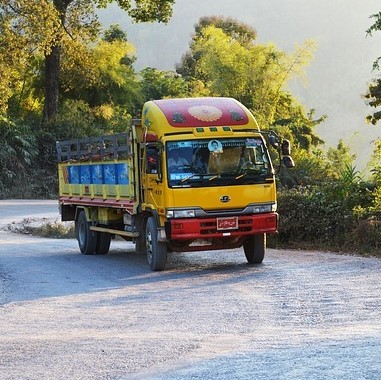 A colorful transport truck driving up a hill. A colorful transport truck driving up a hill.