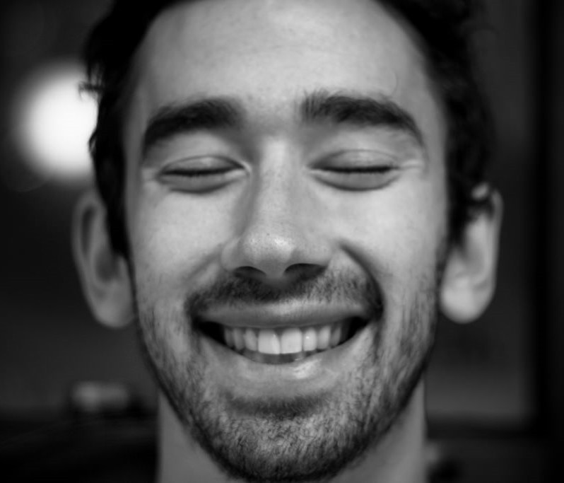 A man smiles with eyes closed. A man smiles with eyes closed.