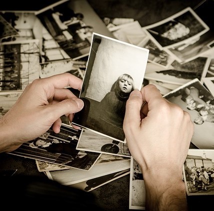 Hands sifting through a box of old photographs. Hands sifting through a box of old photographs.