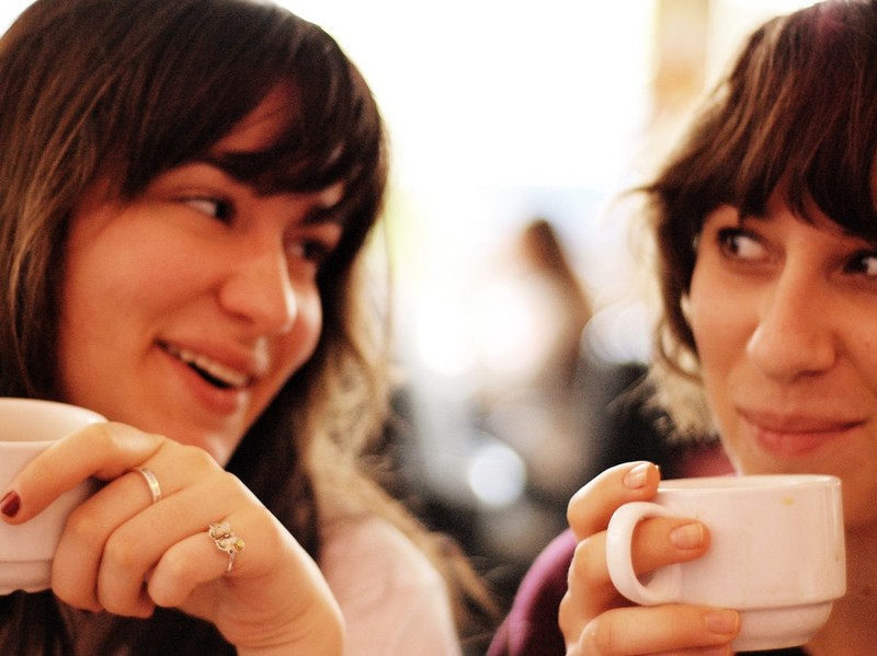 Two close friends have a conversation over coffee. Two close friends have a conversation over coffee.