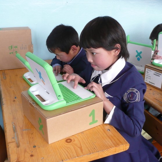 A young schoolgirl in uniform sits at her desk working intently on a laptop. A young schoolgirl in uniform sits at her desk working intently on a laptop.