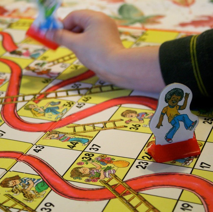 Children playing the game Chutes and Ladders. Children playing the game Chutes and Ladders.