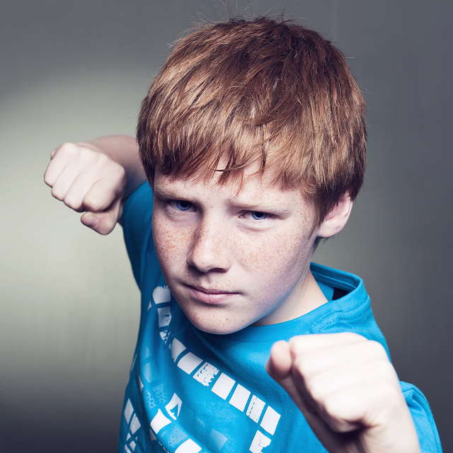 A boy raising his fists. A boy raising his fists.