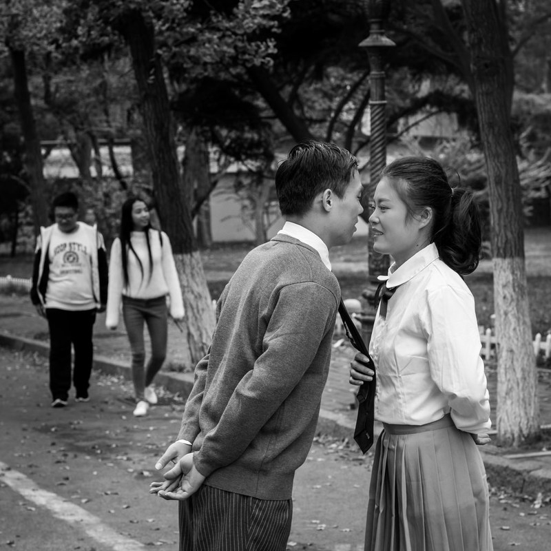 A young man and woman dressed in school uniforms are just about to kiss. A young man and woman dressed in school uniforms are just about to kiss.