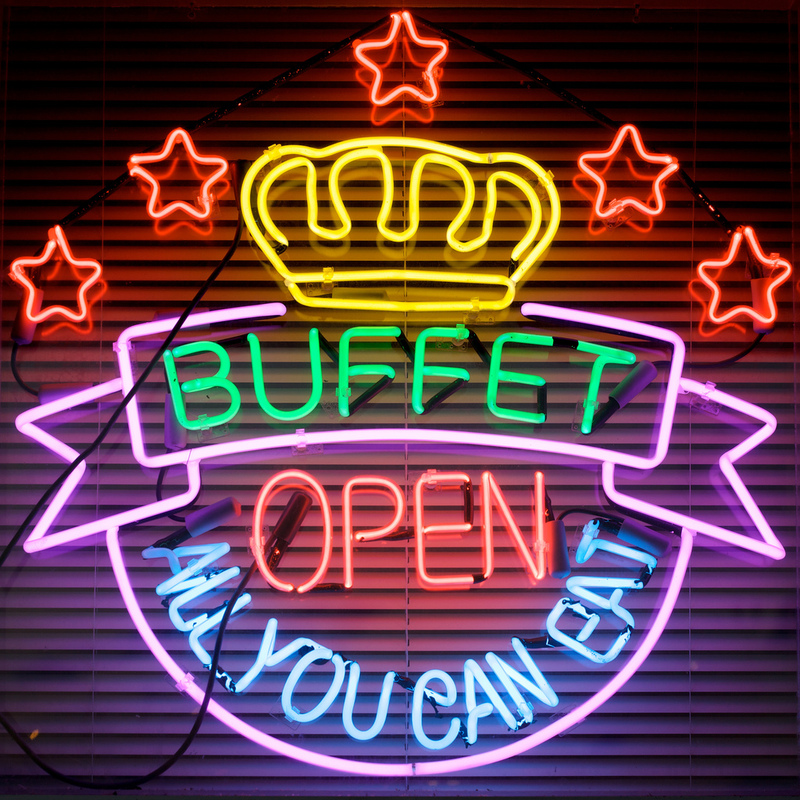 A neon sign advertises an all-you-can-eat buffet. A neon sign advertises an all-you-can-eat buffet.