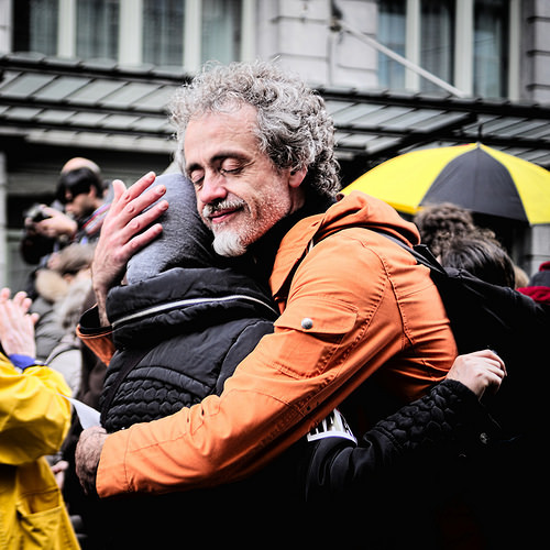 A man and woman embrace in the street. A man and woman embrace in the street.