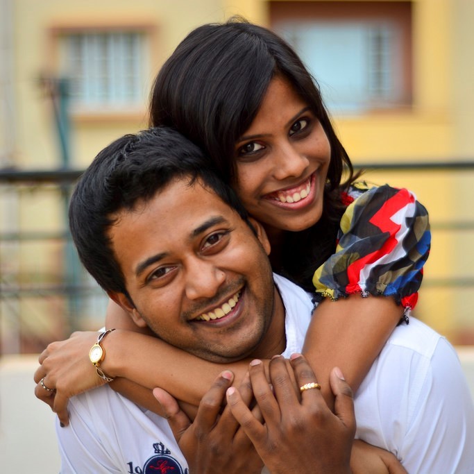 A happy couple embrace and smile broadly. A happy couple embrace and smile broadly.