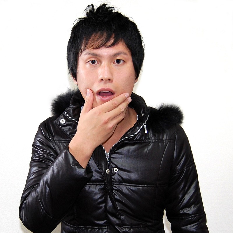 A man puts his hand to his chin in an expression of surprise. A man puts his hand to his chin in an expression of surprise.