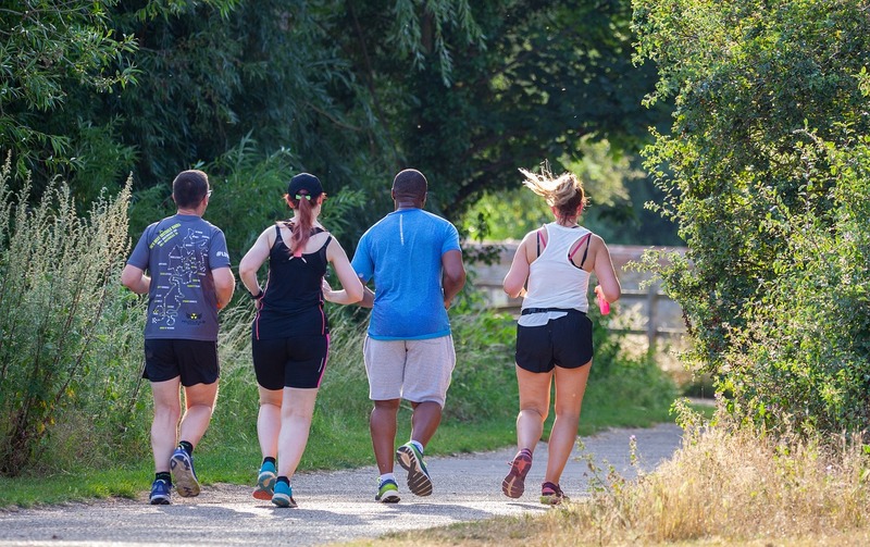 Four people jogging in a park Four people jogging in a park