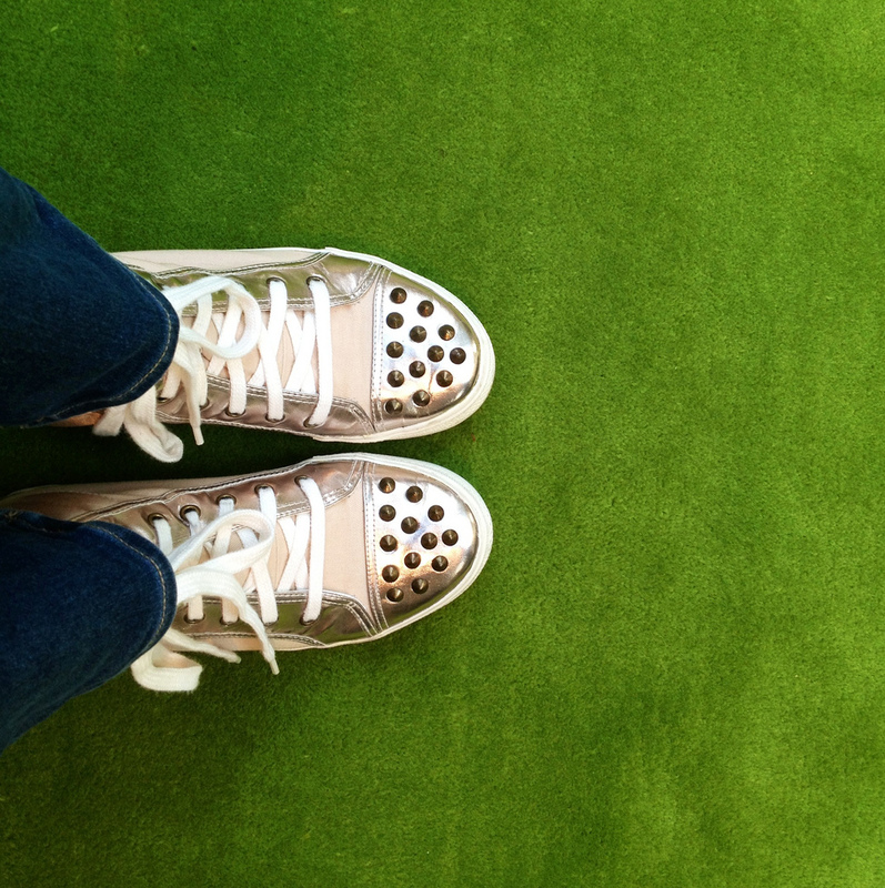 The view from above of some shiny gold sneakers. The view from above of some shiny gold sneakers.