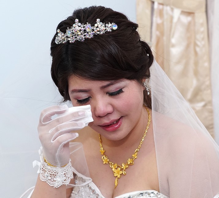 A bride wipes tears from her eyes. A bride wipes tears from her eyes.