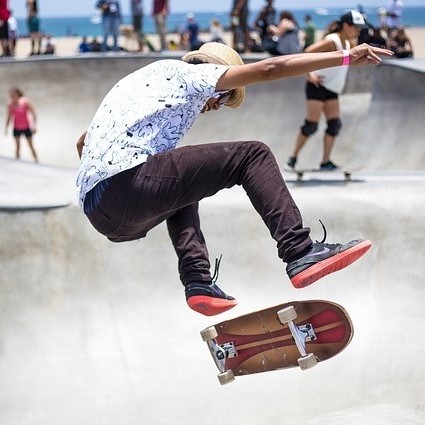 A skateboarder performs a trick at a skate park. A skateboarder performs a trick at a skate park.