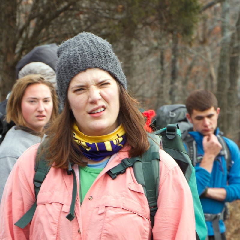 A group of hikers are stopped in the middle of a trail with confused looks on their faces. A group of hikers are stopped in the middle of a trail with confused looks on their faces.