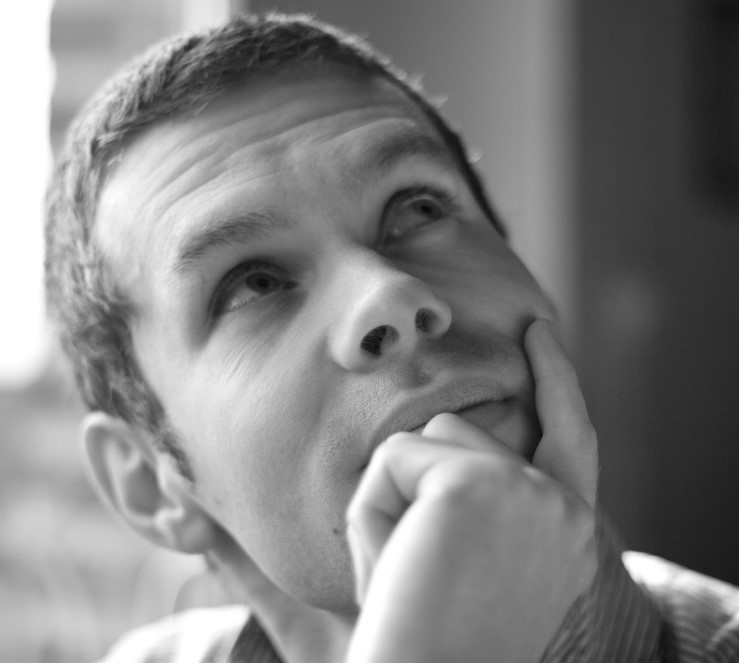 A man sits with a pensive look on his face as if trying to recall something that is just out of reach. A man sits with a pensive look on his face as if trying to recall something that is just out of reach.