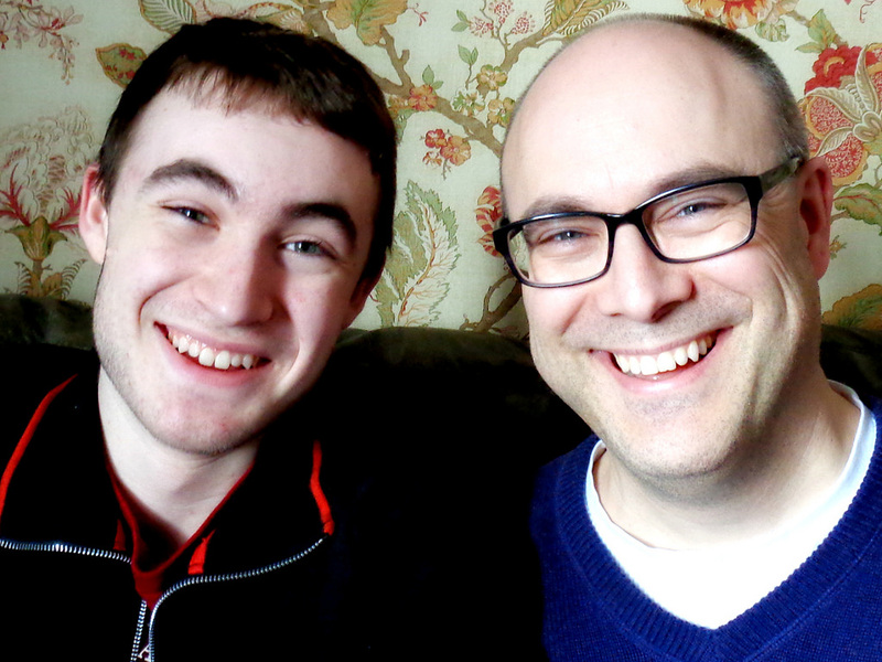 A teen son and his father with a strong family resemblance. A teen son and his father with a strong family resemblance.