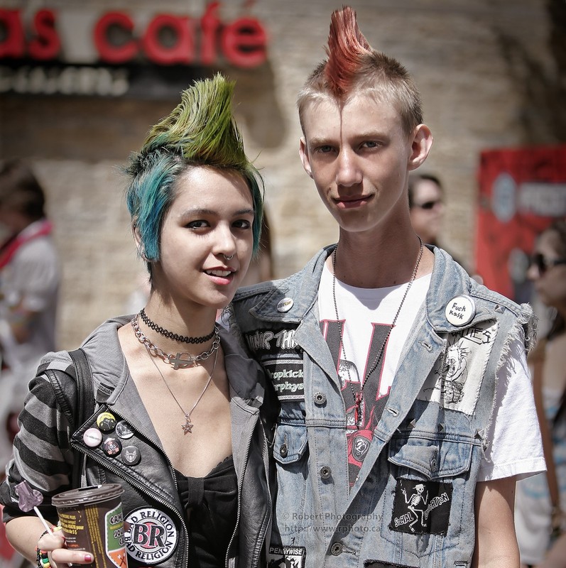 Two teens with colorful Mohawk hairstyles and punk rock clothes Two teens with colorful Mohawk hairstyles and punk rock clothes