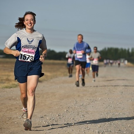 Competitors running down a road during a race. Competitors running down a road during a race.