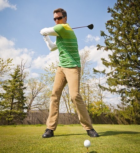 A golfer prepares to tee off. A golfer prepares to tee off.