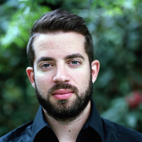 A calm looking man stares coolly into the camera. A calm looking man stares coolly into the camera.