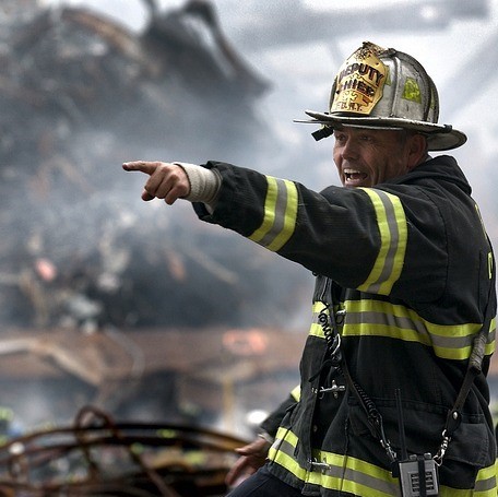 A firefighter calling out and pointing during a call. A firefighter calling out and pointing during a call.