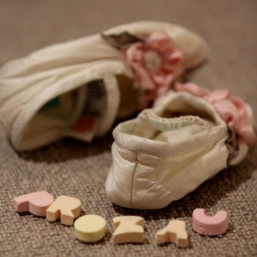 Image of baby booties and the word "Prozac" spelled out in candy letters. Image of baby booties and the word "Prozac" spelled out in candy letters.