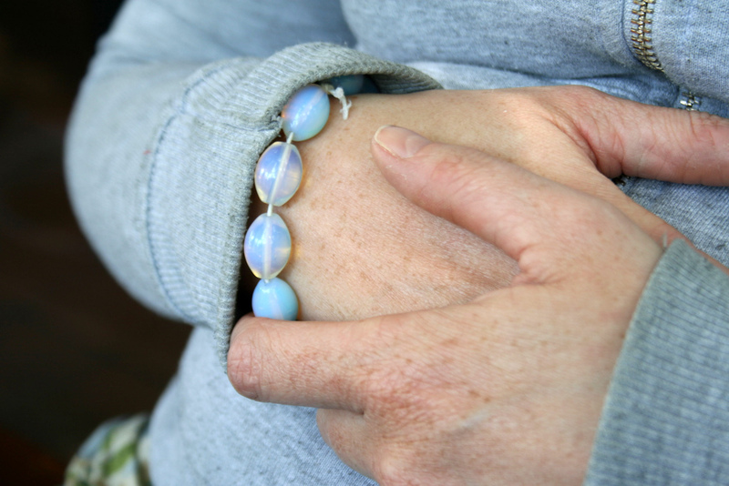 A close up of a woman clutching her hands together. A close up of a woman clutching her hands together.