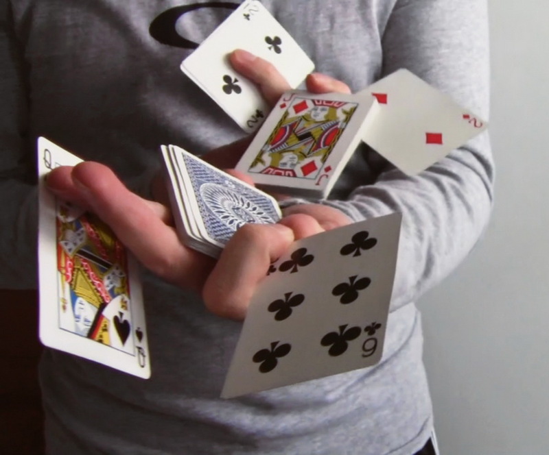 A magician manipulates a deck of cards. A magician manipulates a deck of cards.