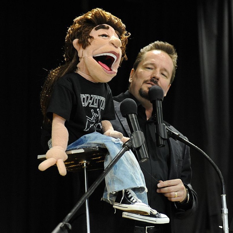 A ventriloquist performs on stage. A ventriloquist performs on stage.