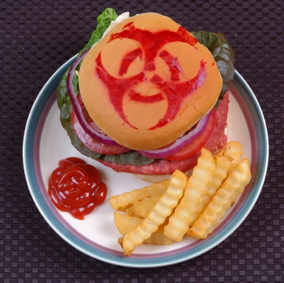 A hamburger with a bio-hazard symbol drawn on the bun with ketchup. A hamburger with a bio-hazard symbol drawn on the bun with ketchup.