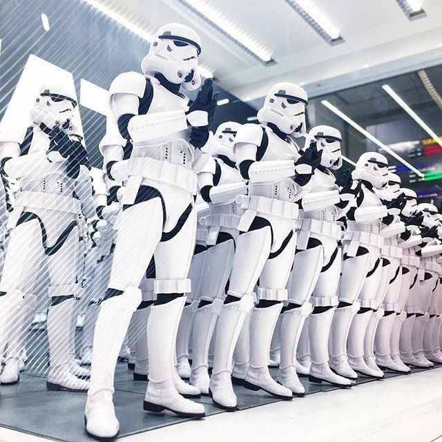 A line of identically dressed stormtroopers from the Star Wars films. A line of identically dressed stormtroopers from the Star Wars films.