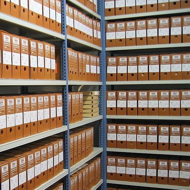 Archive shelves full of document binders. Archive shelves full of document binders.