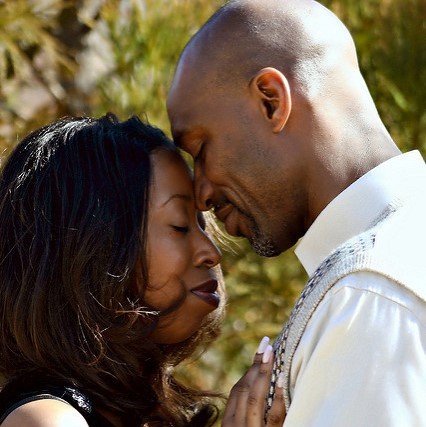 A man and woman in a tender embrace smile with eyes closed. A man and woman in a tender embrace smile with eyes closed.