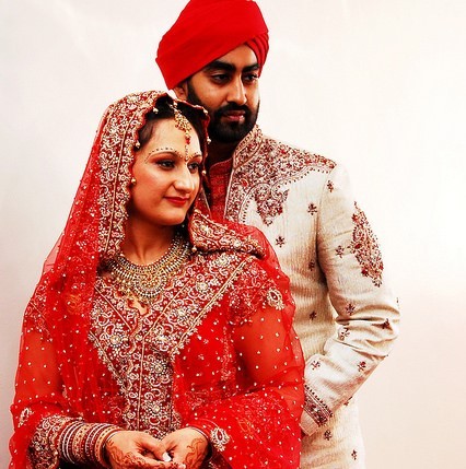 A young couple posing for wedding photos in traditional Indian attire. A young couple posing for wedding photos in traditional Indian attire.