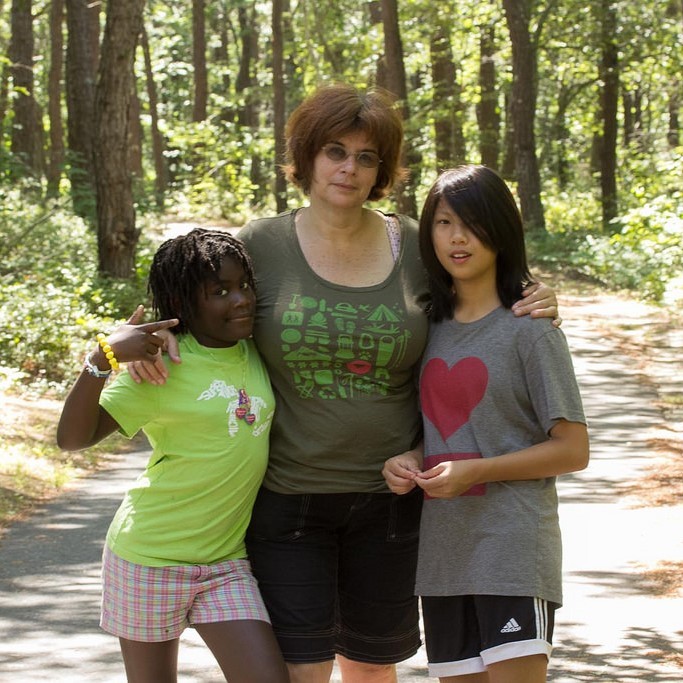 A mother and two adopted daughters. A mother and two adopted daughters.