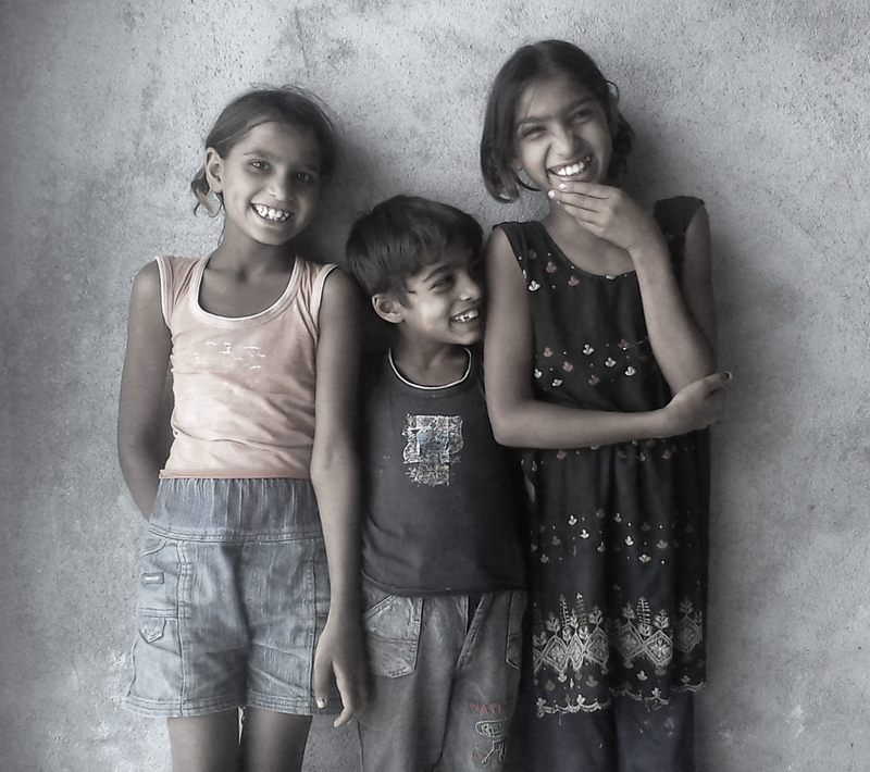 Three smiling siblings. Three smiling siblings.