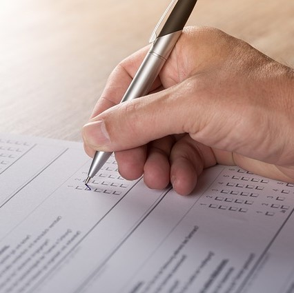 Ticking a box on a survey form. Ticking a box on a survey form.
