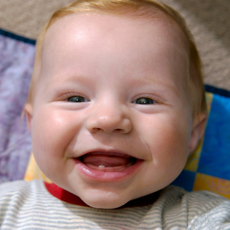 A baby smiling and showing his first tooth. A baby smiling and showing his first tooth.